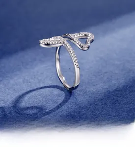 Close-up of double heart leaf ring with silver plating and shimmering crystals