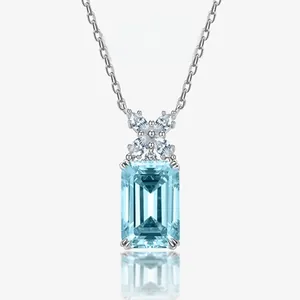 Close-up of emerald cut light blue gemstone pendant with star shaped diamond setting