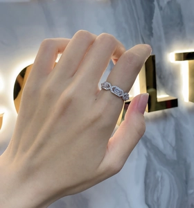 Macro detail of S925 silver geometric ring featuring baguette-cut center stone and pave setting
