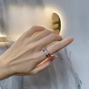 Detail of double row rainbow gemstone ring in silver finish worn on finger