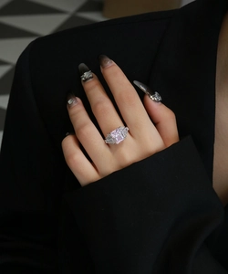 Close-up of S925 silver ring with radiant pink rectangular stone and side baguettes