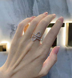 On-finger view of minimalist silver double heart ring with sparkling zircon inlays