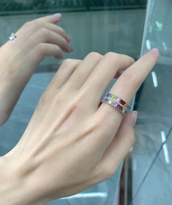Macro detail of a double-row baguette-cut rainbow gemstone eternity ring in sterling silver