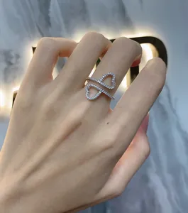 Detail of interlocking double heart sterling silver ring with micro-pave crystals