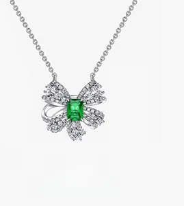 Detailed view of S925 sterling silver bow necklace with emerald-cut green gemstone