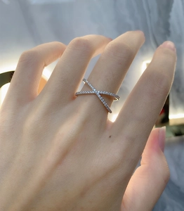 Detailed close-up of a s925 silver criss-cross ring with pavé set cubic zirconia stones