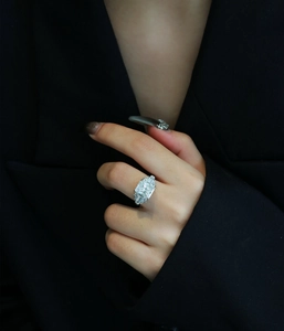 Close-up of S925 sterling silver ring with large ice-cut square zircon on model hand