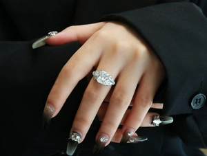 Radiant cut silver cocktail ring with three stones shown on a model hand