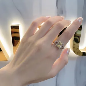S925 silver ring with radiant cut yellow gemstone and pavé diamonds on a crossover band