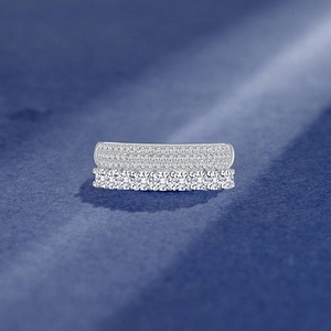 Elegant 925 sterling silver double row pavé and claw set ring on blue background