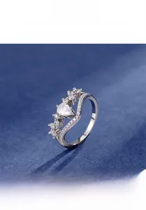 Macro view of 925 sterling silver ring with pear-cut zircon and V-shaped pavé band