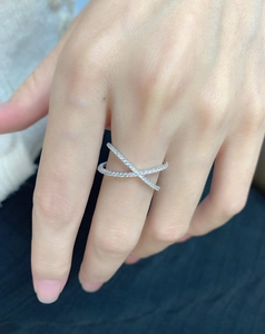 Detail view of s925 silver criss-cross ring featuring pavé set cubic zirconia stones