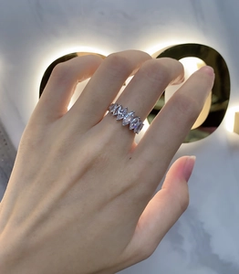 Close-up of 925 sterling silver ring with 7 marquise-cut sparkling stones on finger