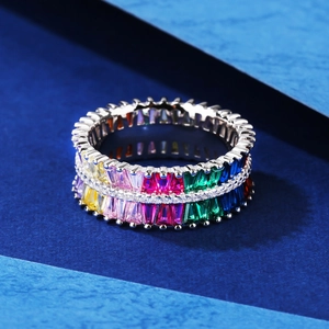 Silver eternity ring featuring double rows of vibrant colorful rectangular gemstones