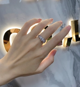 Macro shot of 925 silver ring featuring marquise-cut carbon diamonds on a model's hand