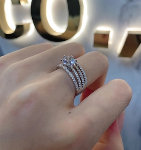 Macro detail of S925 silver multi-layer ring featuring a large round-cut sparkling center stone