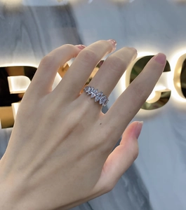 Close-up of 925 sterling silver ring with seven marquise-cut stones on a finger