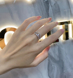 Macro shot of V-shaped sterling silver ring with pear-cut zircon and pave settings