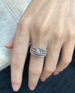 Macro shot of silver multi-layer rings with large central diamond and pave diamond bands