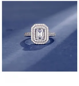 Macro detail of emerald-cut 925 silver ring with double halo and pavé setting
