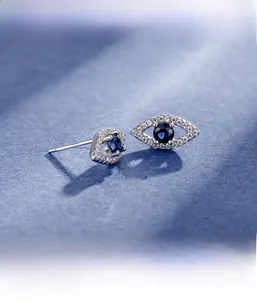 Macro view of S925 silver Evil Eye stud earrings with blue gemstone and micro-inlays
