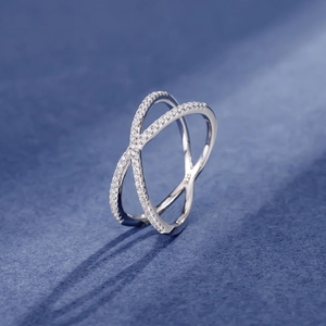 Minimalist S925 sterling silver crisscross ring with pavé-set zircons on blue velvet