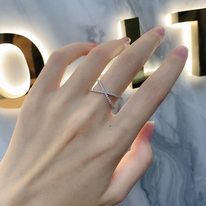 Minimalist S925 sterling silver cross ring with pavé-set white zircons on a model
