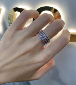 Close-up of S925 silver ring featuring a four-layer pave diamond design with a center stone