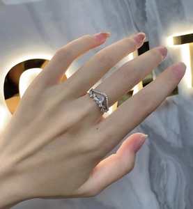 Detailed view of S925 sterling silver pear-shaped diamond V-shaped crown ring on hand