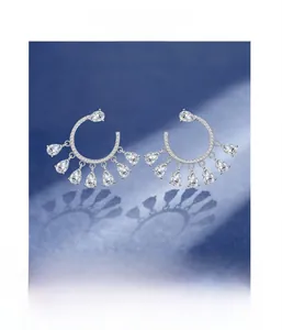 Detail of S925 silver C-shaped fringe earrings featuring drop-cut CZ stones with micro-inlay