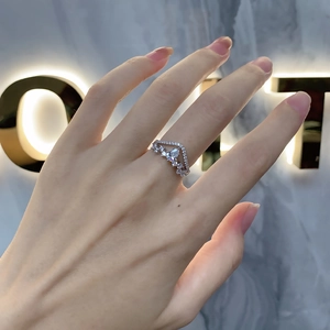 Detailed view of an S925 silver crown-shaped ring with pear-cut zircon on a hand