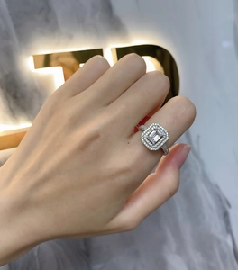Detailed view of rectangular emerald cut 925 silver ring with double halo pavé setting