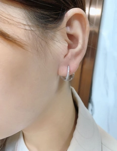 Close-up of S925 sterling silver double hoop earrings with cubic zirconia on female model