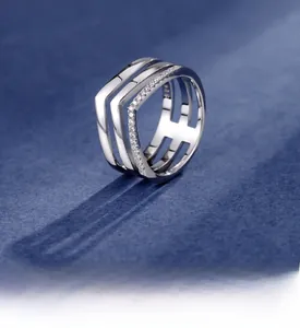 Macro shot of 925 sterling silver multilayer ring featuring sparkling V-shaped crystal pavé