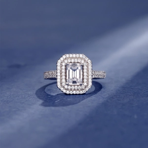 925 silver ring featuring an emerald cut stone with double halo and pave setting