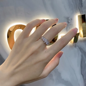 Elegantly worn silver ring featuring seven marquise-cut sparkling stones on a woman's finger