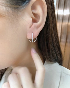 Close-up of S925 sterling silver interlocking double hoop earrings with pavé zircon