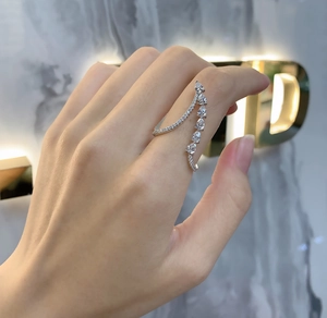 Detailed close-up of a 925 sterling silver ring with pear-shaped stones worn on a finger