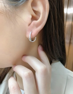 Close-up of S925 sterling silver interlocking hoop earrings with micro-pave cubic zirconia