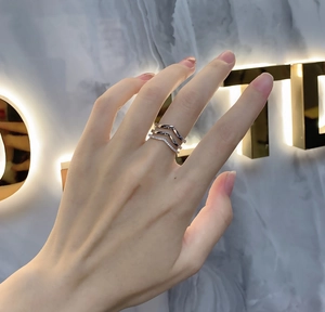Detailed view of three-piece 925 sterling silver layered V-shaped rings on hand
