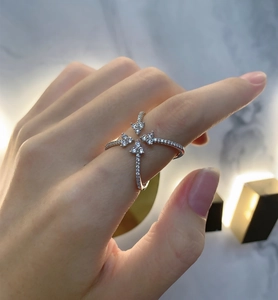 Close-up of sterling silver criss-cross ring with pavé-set zircons on woman finger