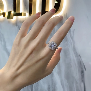 925 silver ring featuring a rectangular main stone with a double halo on model hand
