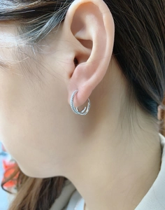 Macro view of S925 sterling silver multi-circle earrings featuring pavé set cubic zirconia