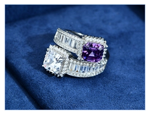 Macro detail of 925 sterling silver rings with purple and white cushion-cut gemstones
