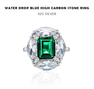 Macro shot of emerald-cut green stone ring with water drop accents in 925 silver