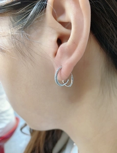 Close-up of S925 sterling silver double hoop earrings with cubic zirconia on female ear