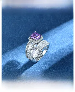 Macro shot of 925 silver ring featuring square purple and white gemstones on blue velvet
