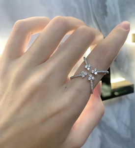 Detailed view of sterling silver ring with four-prong cross star burst and pave zircon