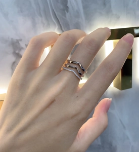 Detailed view of three-piece 925 silver layered V-shaped rings with micro-set diamonds