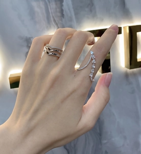Close-up of teardrop and V-shaped 925 sterling silver rings set with sparkling zircons